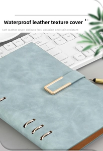 Detail of light blue A5 binder notebook with waterproof matte leather texture and U-buckle