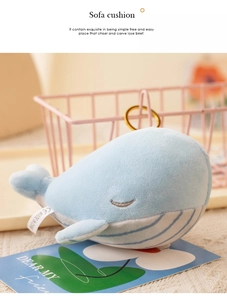 Close-up of cute blue whale plush keychain with metal buckle and soft striped belly