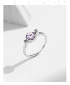 Detailed macro shot of S925 sterling silver ring with a sparkling round purple gemstone