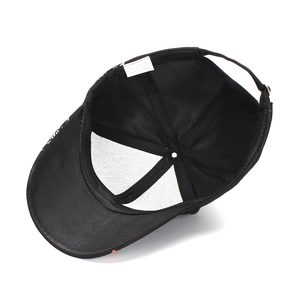 Internal view of black cotton baseball cap showing tidy stitching and 100% cotton label