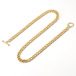 Close-up of 18K gold-plated Cuban chain necklace with T-bar toggle clasp on white background