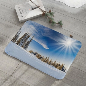 Close-up of winter snow landscape flannel floor mat on light wood floor with pine cones