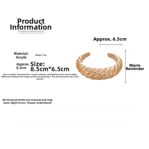 Detailed view of irregular twisted gold acrylic cuff bracelet showing 8.5x6.5cm dimensions