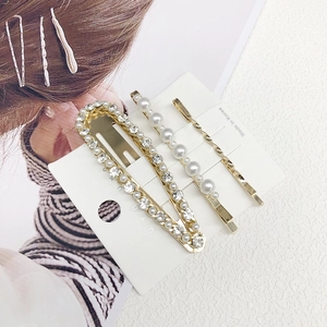 Three-piece gold alloy hair clip set with artificial pearls and sparkling rhinestones