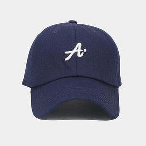 Detailed close-up of navy blue cotton baseball cap with white embroidered letter A