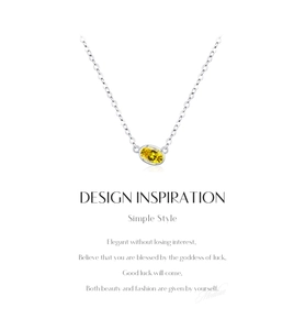Detail view of oval cut yellow gemstone pendant on s925 silver necklace chain