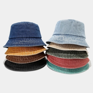 Multiple colors of vintage washed denim bucket hats stacked for outdoor sun protection