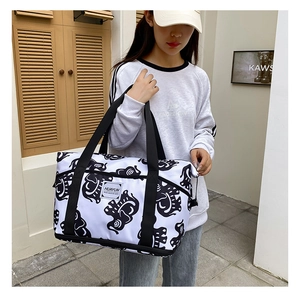 Detail of expandable fitness bag with black elephant print and wet-dry storage pockets