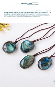 Macro shot of natural labradorite pendants with vivid blue fire on brown braided cords