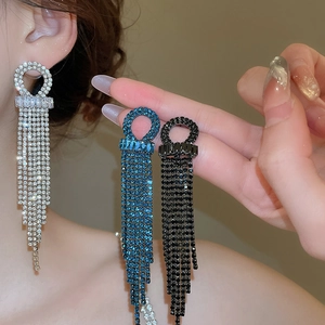 Detailed view of silver, blue, and black long tassel earrings with sparkling rhinestones