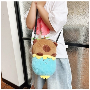 Detail of cute brown plush capybara crossbody bag with blue turtle backpack and nylon strap