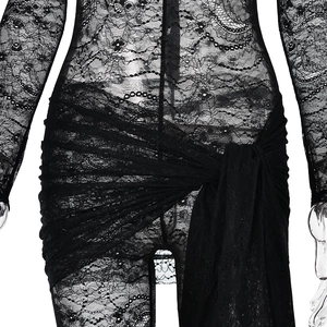 Detail shot of sheer black lace bodysuit with intricate floral patterns and waist tie