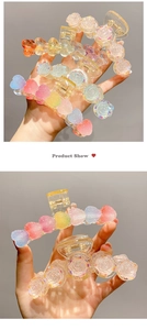 Detailed view of resin flower and gradient heart hair clips with translucent finish
