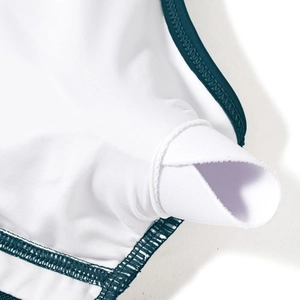 Detail view of the inner pad slot and reinforced stitching on high-waist white swimwear