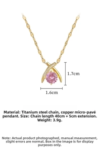 Macro detail of cross pendant featuring pink stone and titanium steel chain dimensions