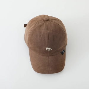 Close-up of brown cotton baseball cap with white animal embroidery and metal buckle detail