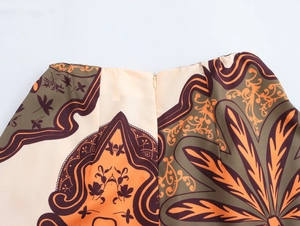 Detail view of paisley print skirt with invisible zipper and smooth satin texture