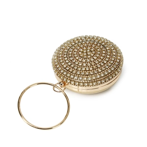 Close-up of circular evening clutch bag with luxury rhinestones and gold ring handle