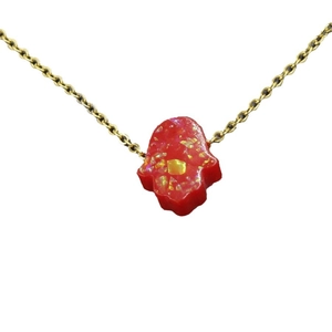 Gold-tone Hamsa Hand necklace featuring a red opal-style pendant with sparkling glitters