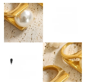 Detail view of a 18K gold-plated titanium ring with a large white imitation pearl setting