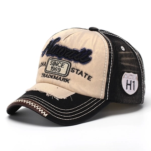 Detail of Hawaii embroidery and vintage distressed denim texture on the baseball cap