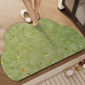 Cloud-shaped green diatom mud bathroom mat with colorful polka dots on wooden floor