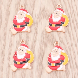 Detailed view of four colorful Santa Claus enamel pendants for DIY jewelry making