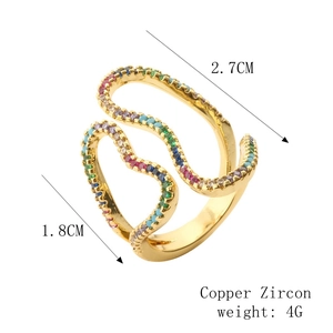 Detail of wave-shaped gold-plated copper ring featuring colorful zircon micro-inlays