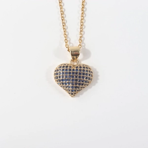Detail of gold plated heart pendant necklace featuring blue zircon micro-pave setting