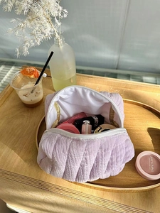 Quilted cotton makeup bag in lavender showing internal capacity and soft texture