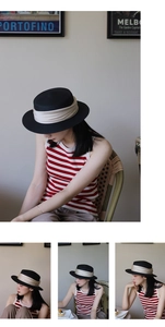 Close-up of vintage black flat top straw hat with beige satin ribbon and elegant brim