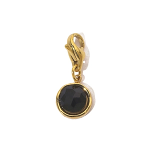 Macro view of gold stainless steel sun pendant with black gemstone and lobster clasp