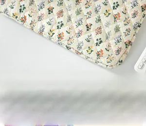 Detail of floral quilted tablet sleeve with diamond stitching and soft fabric texture