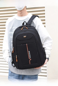 Close-up of black backpack with orange zippers and water-resistant sport fabric detail