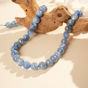 Close-up of blue stone beads with natural texture on minimalist hand bracelet