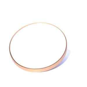 Modern gold round jewelry display tray for earrings and rings on white background
