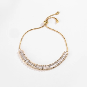 Detail of gold box chain bracelet featuring a row of rectangular cubic zirconia stones