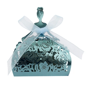 Close-up of light blue laser-cut princess dress favor box with a delicate silk ribbon