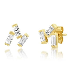 Detailed view of three-stone gold fish studs with marquise-cut zircons and reflections