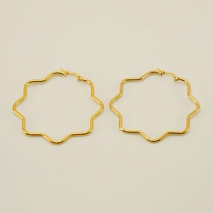 Detailed view of octagon-shaped wavy 18K gold earrings with smooth polished finish