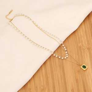 Double-layered gold emerald necklace with faux pearls and square green stone pendant