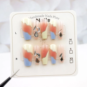 Macro detail of geometric tricolor press-on nails with silver glitter and rhinestone accents