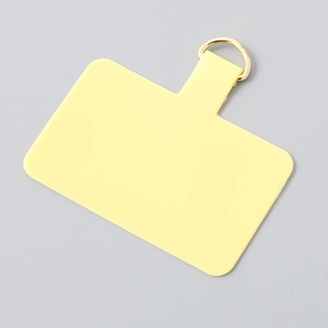 Detailed view of yellow TPU phone tether tab with a premium golden D-ring connector
