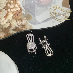 Creative silver chair earrings with sparkling cubic zirconia on a black velvet base