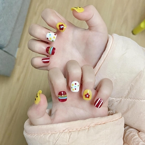 Kids press-on nails set with rainbow flowers, colorful polka dots, and smiley face designs