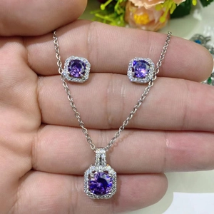 Detail of square purple zircon necklace and stud earrings set with halo diamond border