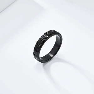 Macro shot of black tulip leaf texture on a polished stainless steel ring band