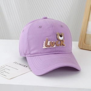 Close-up of lavender cotton baseball cap with 3D rubber lucky bear patch and curved brim