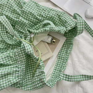 Green and white plaid canvas tote bag with drawstring closure for daily lifestyle use