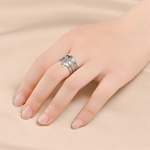 Detail of silver titanium stacked rings with traditional Chinese coin motif and engraving